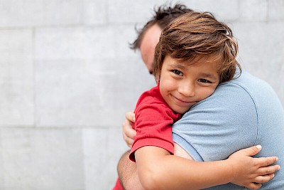 boy hugging dad